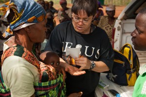 Brenda giving the sick baby's vitamins.